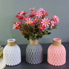 3 vases with flowers in center vase, white, gray, rose